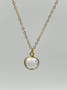 Elevate your style with our stunning 24K bezel crystal quartz pendant necklace. This exquisite piece features a beautifully faceted crystal quartz gemstone, known as the birthstone for April, delicately set in a luxurious 24K gold bezel. The transparent or clear crystal quartz is associated with healing properties, believed to cleanse and balance energy, enhance clarity and focus, and promote spiritual growth and connection. Each side of the crystal quartz is expertly faceted, adding brilliance Faceted Clear Crystal Necklaces As Gifts, Clear Faceted Crystal Necklace For Gift, Clear Faceted Crystal Necklace Gift, Yellow Faceted Necklace For Gifts, Faceted Clear Crystal Necklace For Gift, Gold Faceted Pendant Crystal Necklace, Faceted Quartz Necklace For Gift, 14k Gold-filled Crystal Necklaces With Delicate Chain For Gifts, Balance Energy