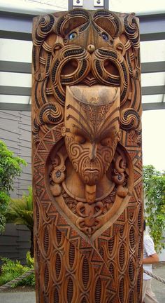 a wooden sculpture with an intricate design on it's face