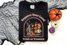 Vintage 90s Support Your Local Trick Or Treaters Shirt ⭐ Welcome to K & K Custom Tees! ⭐  - Indulge in pure comfort with our Comfort Colors Shirt. Soft, relaxed, and available in a variety of colors! ⭐SHIRT DETAILS⭐  -High Quality fabric  -100% ring-spun US cotton -Designed and printed in the USA  ⭐ PLEASE NOTE ⭐ -For an oversized look, we suggest to size up 1-2 sizes. These shirts run like standard unisex tees. Please see size chart for a more fitted look!  -Colors may vary based on your monitor or screen display! ⭐CARE INSTRUCTIONS ⭐ -Machine wash inside out in cold water  -Tumble dry medium or hang to dry  -Do not dry clean or iron directly onto the design  ⭐PROCESSING & SHIPPING TIMES ⭐ -Processing time: 3 to 5 business days  -Shipping time: US - 2 to 5 business days  ⭐OUR GOAL⭐  -Deli 90s Style Halloween Tops With Screen Print, 90s Style Halloween Screen Print Tops, 90s Halloween Screen Print Tops, 90s Style Halloween Tops, 90s Halloween T-shirt With Screen Print, Retro Halloween T-shirt For Streetwear, Retro Halloween Streetwear T-shirt, Halloween Graphic T-shirt Relaxed Fit, Retro Halloween T-shirt Pre-shrunk