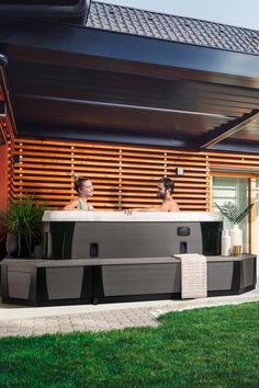 two people sitting in an outdoor hot tub