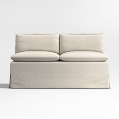 a white couch sitting on top of a white floor