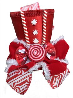 a red and white christmas decoration with candy canes on it's headband