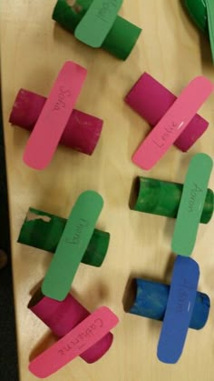 several pieces of colored paper are arranged in the shape of popsicles with writing on them