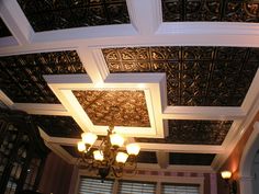 a chandelier hanging from the ceiling in a room with ornate designs on it