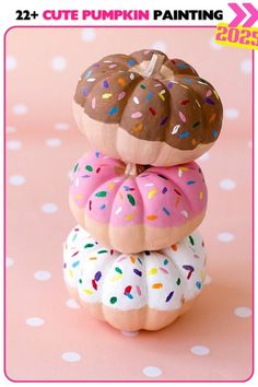 three donuts stacked on top of each other with sprinkles and chocolate frosting