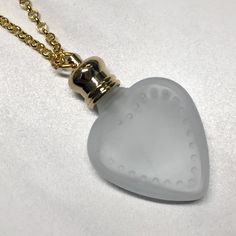 This vintage inspired necklace is made with a small frosted heart crystal perfume bottle. The glass bottle is 4mm, The neck and gold cap is 1.5mm so the overall length is 5.5mm. It can hold 4ml of your favorite perfume. The small cap screws off and it comes with a long 28 inch gold plated chain which can slip right over your head. The bottle has a flat round carnelian bead that accents this necklace. This necklace is very pretty would make a great gift! Elegant Glass Necklace For Keepsake, Vintage Heart-shaped Necklace With Charms, Spiritual Heart-shaped Necklace With Vintage Charm, Elegant Glass Keepsake Necklace, Heart-shaped Locket Necklace With Vintage Charm For Gifts, Heart Perfume Bottle, Heart Perfume, Vintage Glass Heart Necklace, Perfume Bottle Necklace Pendants