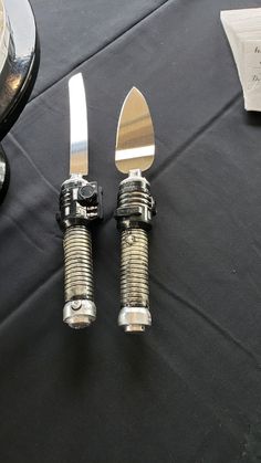 two forks and spoons sitting next to each other on a table