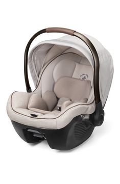 an infant car seat that is white and brown