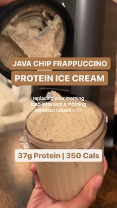 a person holding a jar of protein ice cream in front of a blender with the words, java chip frapuccino protein ice cream