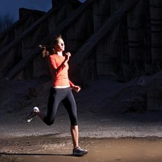 a woman running on the beach at night