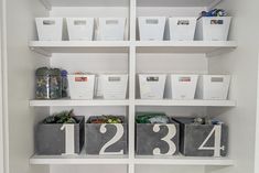 the shelves have bins with numbers on them