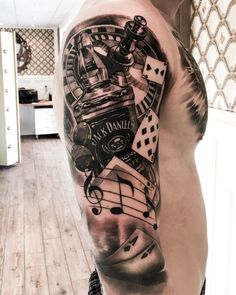 a man's half sleeve with musical notes, dices and other things on it