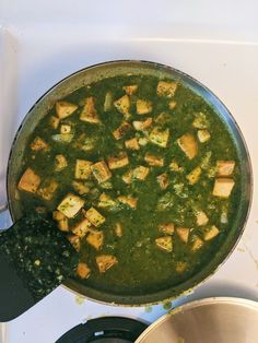 a pan filled with food sitting on top of a stove