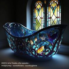 a glass bathtub sitting in front of a stained glass window with birds on it