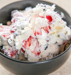 a bowl filled with fruit salad on top of a table