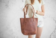 "Leather tote bag. One of the best selling bags of this season. Can serve as a gift to your family members or just a friend. We can put your initials on this product or perform any other modification, especially for you! BAG MAKES in 4 SIZES: Small: 13\" wide x 11.5\" tall [33 cm wide x 29 cm tall] Medium: 15\" wide x 12\" tall [38 cm wide x 30 cm tall] Large: 18\" wide x 12\" tall [45 cm wide x 30 cm tall] Extra Large: 21\" wide x 13\" tall [53 cm wide x 33 cm tall] PERSONALIZATION: Pick any id Casual Daily Use Laptop Bag, Trendy Everyday Laptop Bag With Zipper Pocket, Trendy Laptop Bag With Zipper Pocket For Everyday, Casual Tote Laptop Bag With Zipper Closure, Casual Laptop Tote Bag With Sleeve, Trendy Leather Laptop Bag With Sleeve, Trendy Leather Laptop Bag For Daily Use, Casual Laptop Shoulder Bag For Shopping, Casual Shoulder Laptop Bag For Shopping