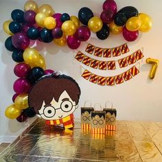 a birthday party with balloons and decorations for harry potter's birthday, including an image of her face on the table