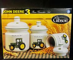 the john deere 3 piece kitchen set is white and has yellow tractors on it