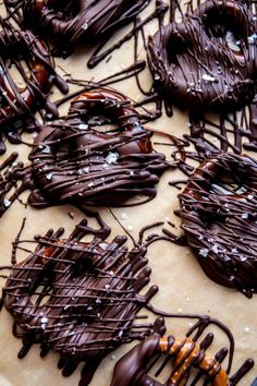 chocolate covered donuts sitting on top of a table