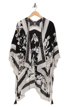 Vivacious floral printing blooms across a lightweight ruana featuring dramatic wide sleeves for an ultrachic, layered look. 40" length 100% rayon Hand wash, dry flat Imported Model stats: 5'10" height, 32" bust, 25" waist, 36" hip. Model is wearing size One Size. Elegant Oversized Poncho For Spring, Oversized Black Summer Poncho, Spring Floral Print Chic Kaftan, Spring Floral Print Shawl Kimono, Spring Shawl Kimono With Floral Print, Chic Floral Print Spring Kaftan, Floral Print Shawl Kimono For Spring, Chic Floral Print Kaftan For Spring, Spring Bohemian Viscose Kaftan