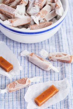 several pieces of food sitting on top of a blue and white table cloth next to a bowl