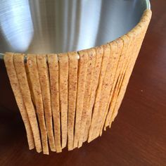 some crackers in a metal bowl on a table