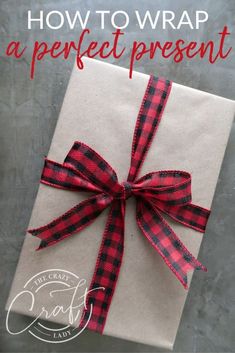 a present wrapped in brown paper with red and black checkered ribbon on the top