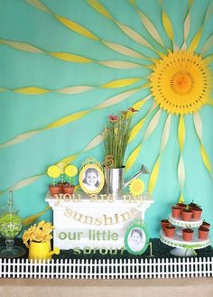 a table topped with cakes and cupcakes next to a wall