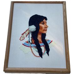 an embroidered portrait of a native american woman