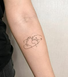 a woman's arm with a small world map tattoo on the left inner arm