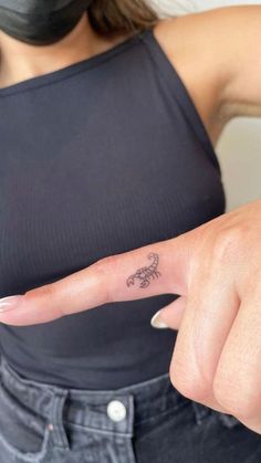 a woman with a small tattoo on her finger