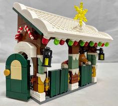 there is a small building made out of legos and it looks like christmas decorations