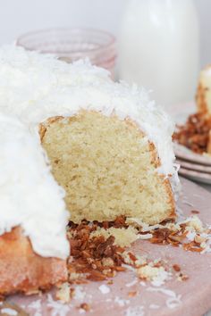 a cake with white frosting and coconut on top