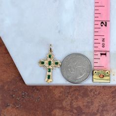 Estate/ vintage 18KT yellow gold ornate detail cross pendant with genuine, green emeralds. Chain shown in pictures is sold separately. Makes a fantastic gift for the holidays, birthday gift, or a gift of self-appreciation! Length: 32mm including bail; 27mm not including bail Width: 21mm Bail measures: 5mm x 6mm Weight: 1.56 grams Flat Back (6) square genuine, green emeralds Approx. 1.65 carat emeralds Stamped 18K Excellent estate condition May Birthstone Cross Pendant Jewelry Gift, Elegant Green Cross Jewelry, Ornate Engraved Cross Pendant Jewelry, Elegant Green Cross-shaped Jewelry, 14k Gold Engraved Cross Pendant Charm, Engraved Yellow Gold Cross Pendant, Emerald Cross Pendant, Green Spiritual Cross Pendant Jewelry, 14k Gold Tarnish-resistant Cross Pendant Jewelry