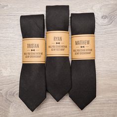 three black ties with brown labels on them