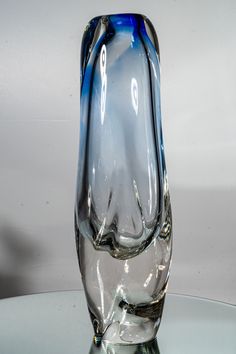 a glass vase sitting on top of a table