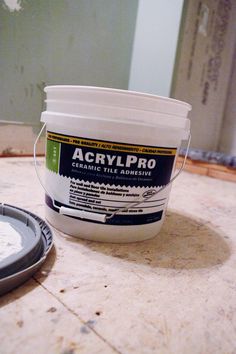 a bucket of acrylpro sitting on top of a table