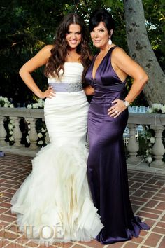 two women standing next to each other in dresses