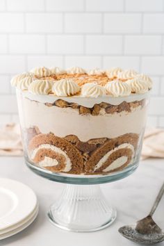 pumpkin trifle no bake dessert in a glass dish on a white counter top