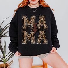 This trendy, leopard Mama sweatshirt is the perfect addition to your wardrobe. Made from polyester and cotton this sweatshirt is durable and cozy. It also features a ribbed knit collar, so it retains its shape even after washing and there are no itchy side seams. This aesthetic sweatshirt is great for relaxing at home, hanging with the kids or running errands.  *SIZING INFO* Please check the size chart for your perfect fit. This is a unisex sweatshirt, and most women find their typical size work Fall Leopard Print Tops With Letter Design, Fall Leopard Print Top With Letter Details, Aesthetic Sweatshirt, Trendy Crewneck, Womens Sweatshirts, Mama Sweatshirt, Gift For Friend, Lightning Bolt, Knit Collar