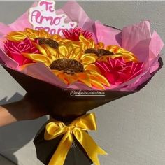 a person holding a bouquet of sunflowers with a happy birthday sign on it