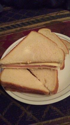 a sandwich cut in half sitting on top of a white plate