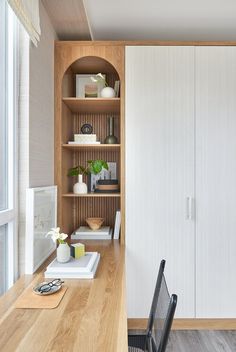 a room with a desk, bookshelf and shelves