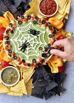 a platter filled with chips, salsa and guacamole