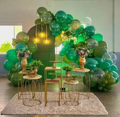 a room filled with balloons and tables next to each other on top of a rug