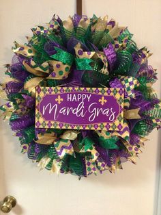 a happy mardi gras wreath hanging on the front door