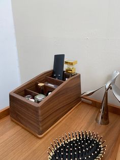 a hair brush, comb and other items are on the floor next to a desk