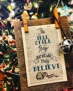 the bell still rings for all who believe christmas ornament on a book page