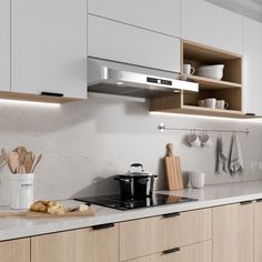 a kitchen with white cabinets and wooden counter tops, along with utensils on the stove