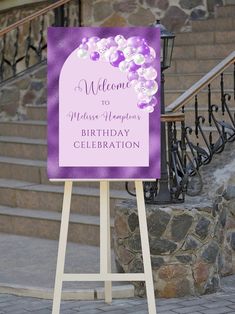 a welcome sign with balloons on it in front of stairs